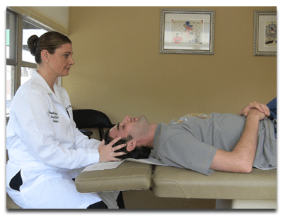 Dr. Olex performing a cranial osteopathic treatment